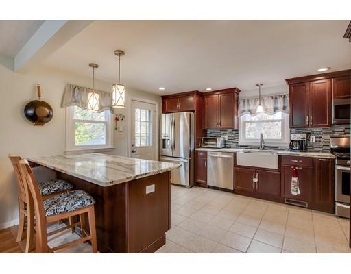 10 Riverside Road Billerica, MA 01821 - Photo 5 of 28 a kitchen with stainless steel appliances granite countertop a sink a stove and a refrigerator