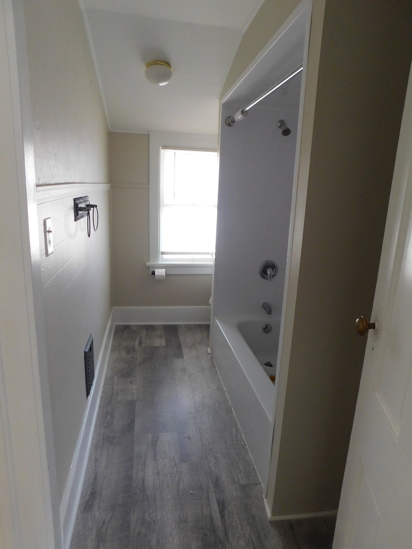307 South Main Street Algonquin, IL 60102 - Photo 13 of 15 wooden floor in an empty room with a window