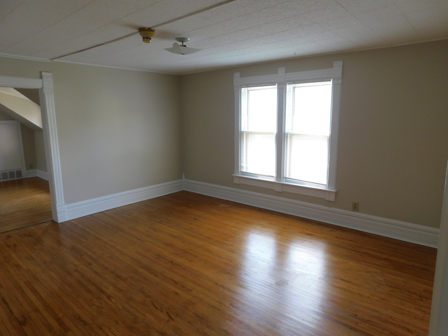 307 South Main Street Algonquin, IL 60102 - Photo 8 of 15 an empty room with wooden floor and windows