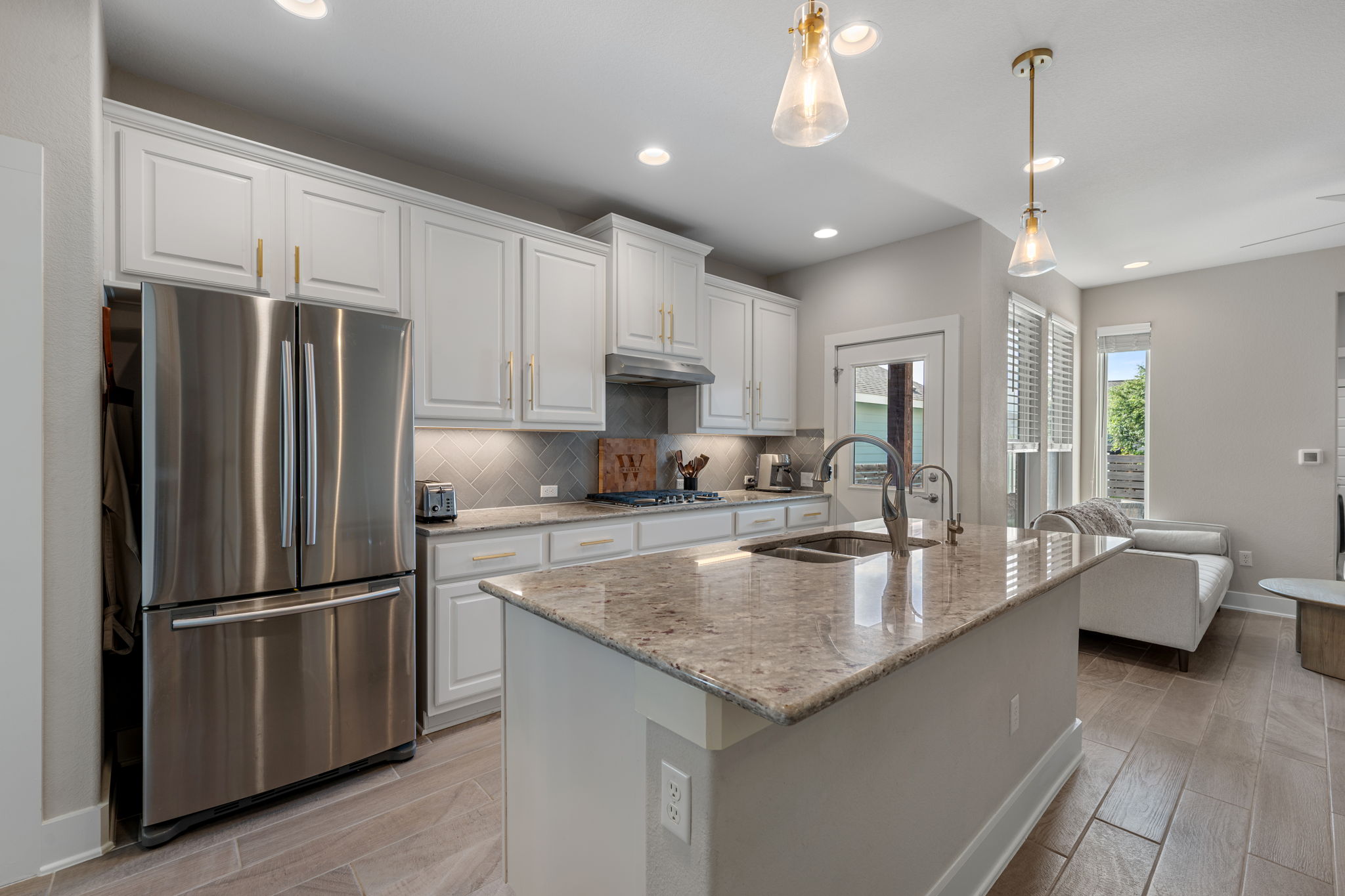 5409 Fox Wing Way Austin, TX 78747 - Photo 4 of 26 Culinary dreams come alive in this well-appointed kitchen, featuring a spacious island and quality appliances.