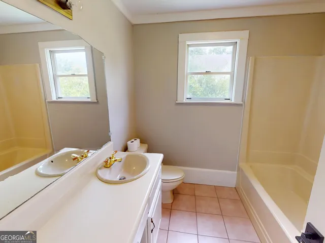 a bathroom with a sink a toilet and tub