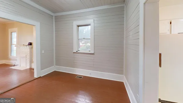 a view of a room with wooden floor and a window