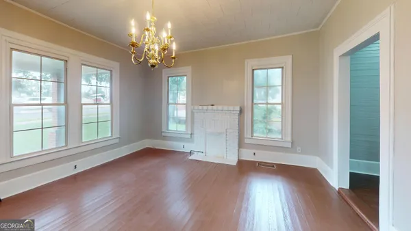 a kitchen with stainless steel appliances a refrigerator sink and white cabinets