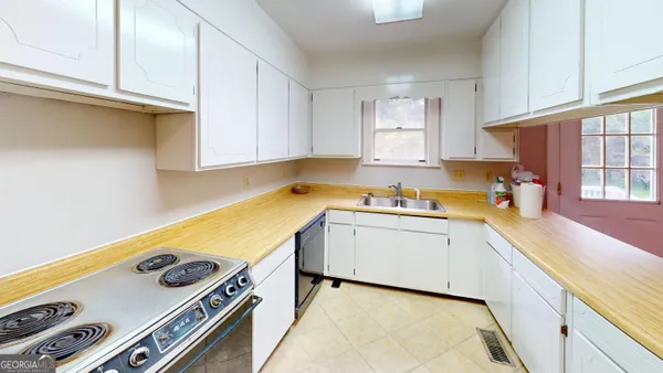 a view of a kitchen with wooden floor and a window