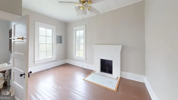 a view of bedroom with wooden floor