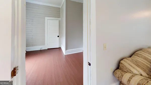 a view of an empty room with window and fire place
