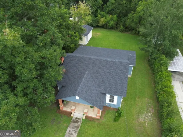 an aerial view of a house with a yard basket ball court and outdoor seating