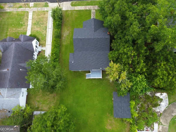 an aerial view of a house with a yard