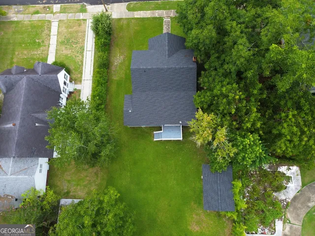 an aerial view of a house with a yard