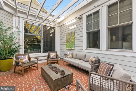 a balcony with furniture and a rug