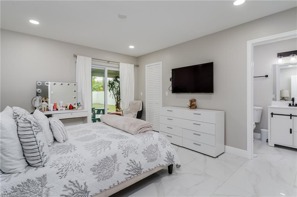 5170 19th Court Southwest Naples, FL 34116 - Photo 11 of 32 a bedroom with a bed and a flat screen tv