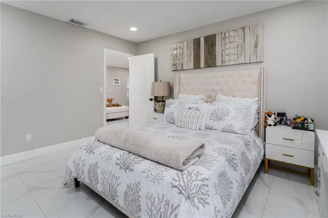 a bedroom with a bed and a couch