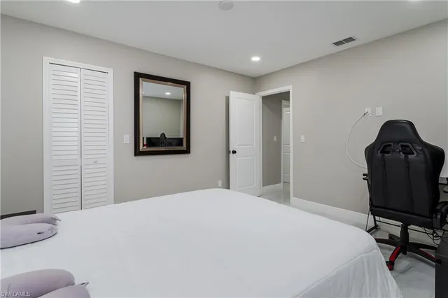 a bedroom with a bed and a chair