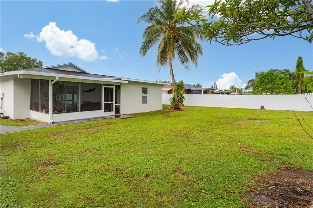 5170 19th Court Southwest Naples, FL 34116 - Photo 29 of 32 a view of a house with a backyard and a tree