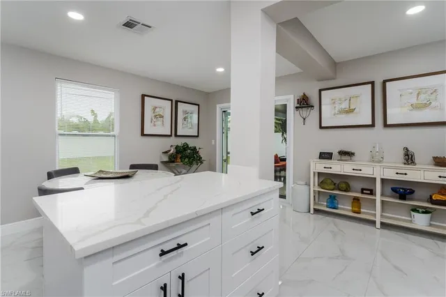 a kitchen with stainless steel appliances a stove and cabinets