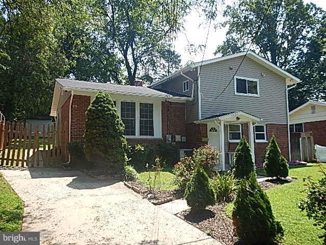 4406 Mahan Road Silver Spring, MD 20906 - Photo 1 of 12 a front view of a house with a yard and potted plants