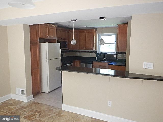 4406 Mahan Road Silver Spring, MD 20906 - Photo 3 of 12 a kitchen with refrigerator and cabinets