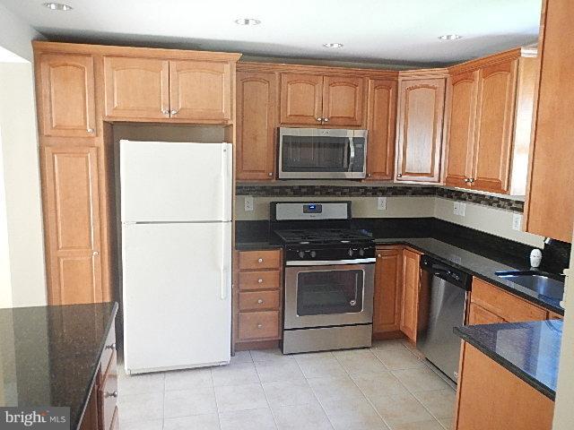 4406 Mahan Road Silver Spring, MD 20906 - Photo 5 of 12 a kitchen with a refrigerator stove and microwave