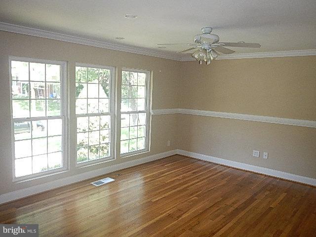 4406 Mahan Road Silver Spring, MD 20906 - Photo 7 of 12 a view of an empty room with a window and wooden floor