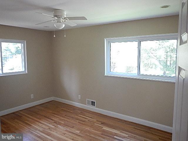 4406 Mahan Road Silver Spring, MD 20906 - Photo 8 of 12 a view of a room with wooden floor and windows