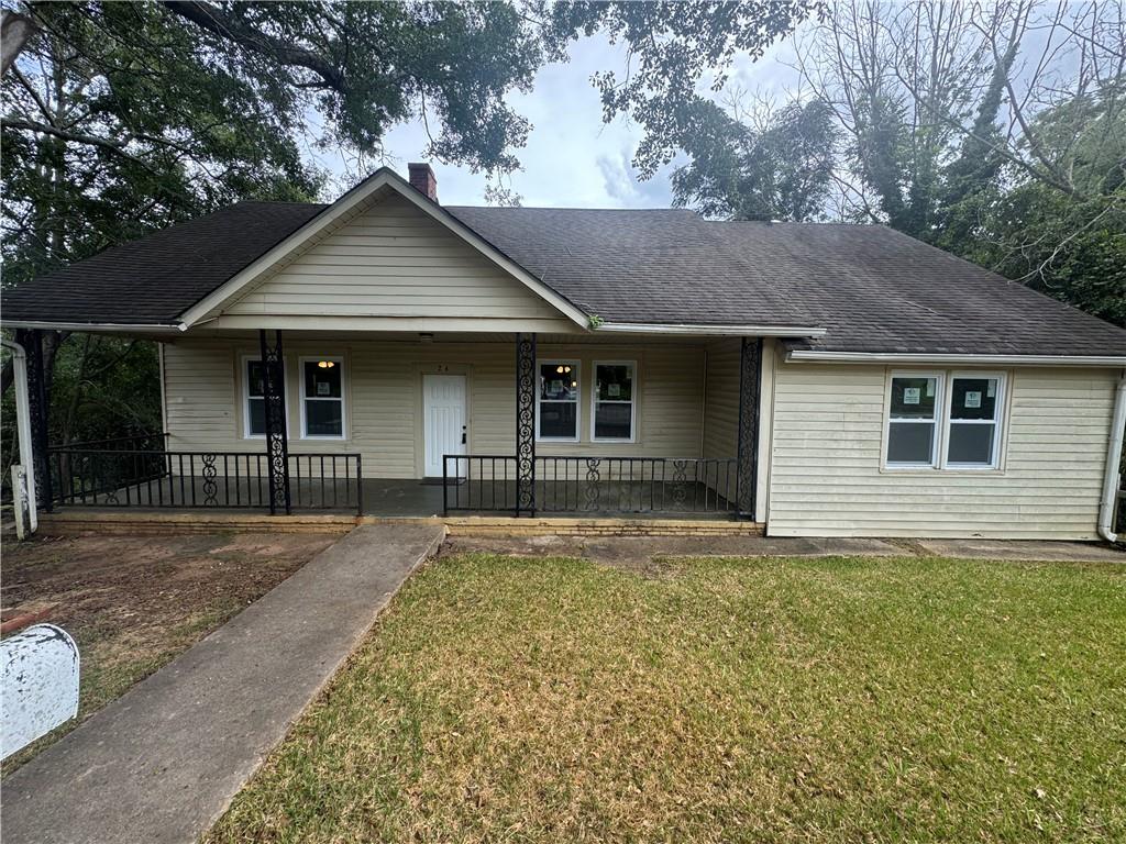 24 Lower Street Valley, AL 36854 - Photo 1 of 18 View of front of house featuring a porch, a front yard, roof with shingles, and a chimney