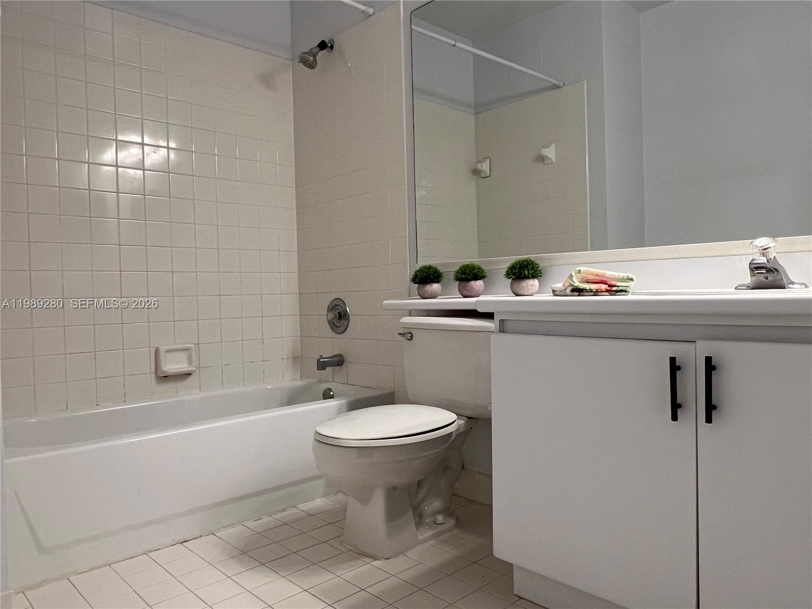 543 Racquet Club Road, Unit 33 Weston, FL 33326 - Photo 25 of 28 a bathroom with a sink toilet and shower