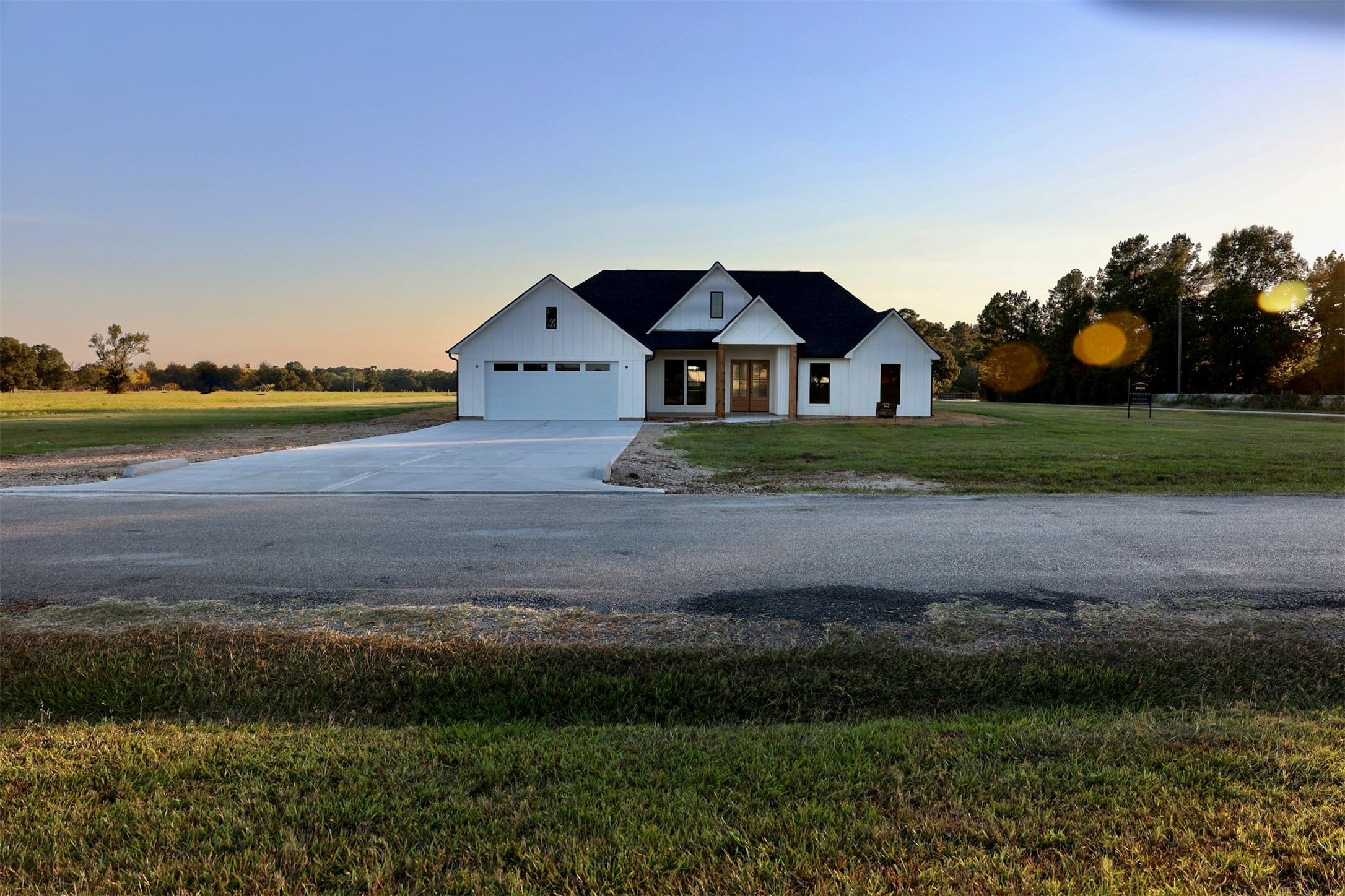 966 Jones Road New Waverly, TX 77358 - Photo 4 of 9 a front view of a house with a yard and garage