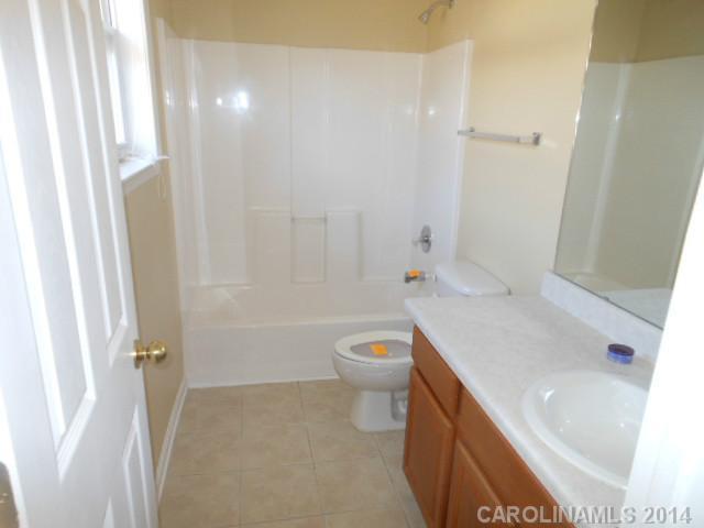 17311 Villanova Road, Unit 84 Huntersville, NC 28078 - Photo 12 of 14 a bathroom with a sink a toilet and shower