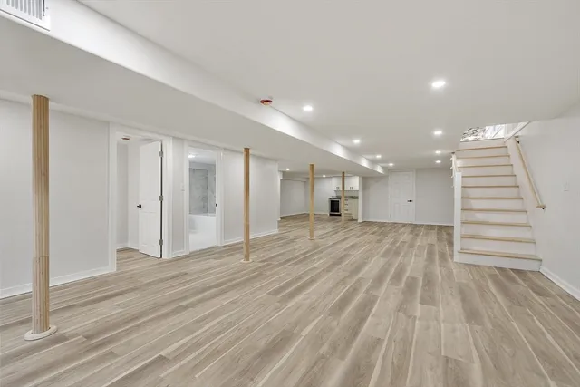 a view of an empty room with wooden floor
