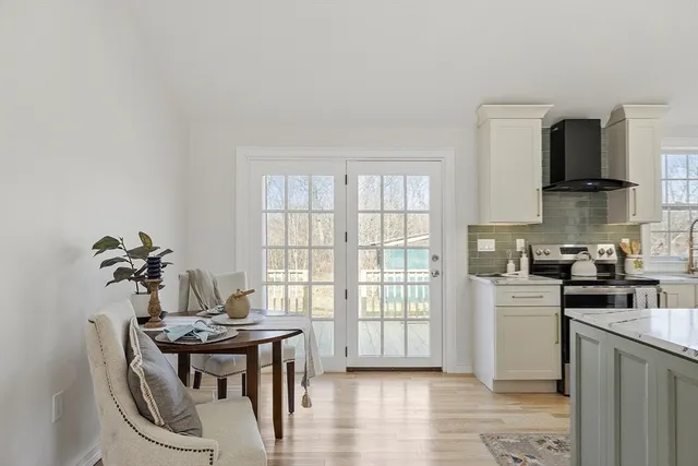 a kitchen with stainless steel appliances granite countertop a stove a sink a refrigerator and a microwave