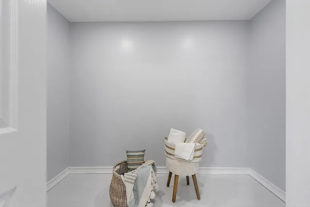 a bathroom with a sink and a chair