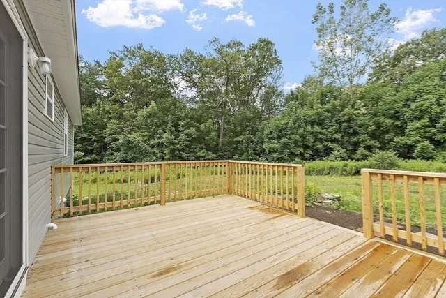 a view of a wooden deck with a yard