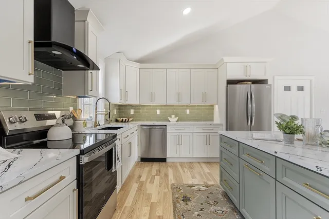 a kitchen with a sink stove and refrigerator