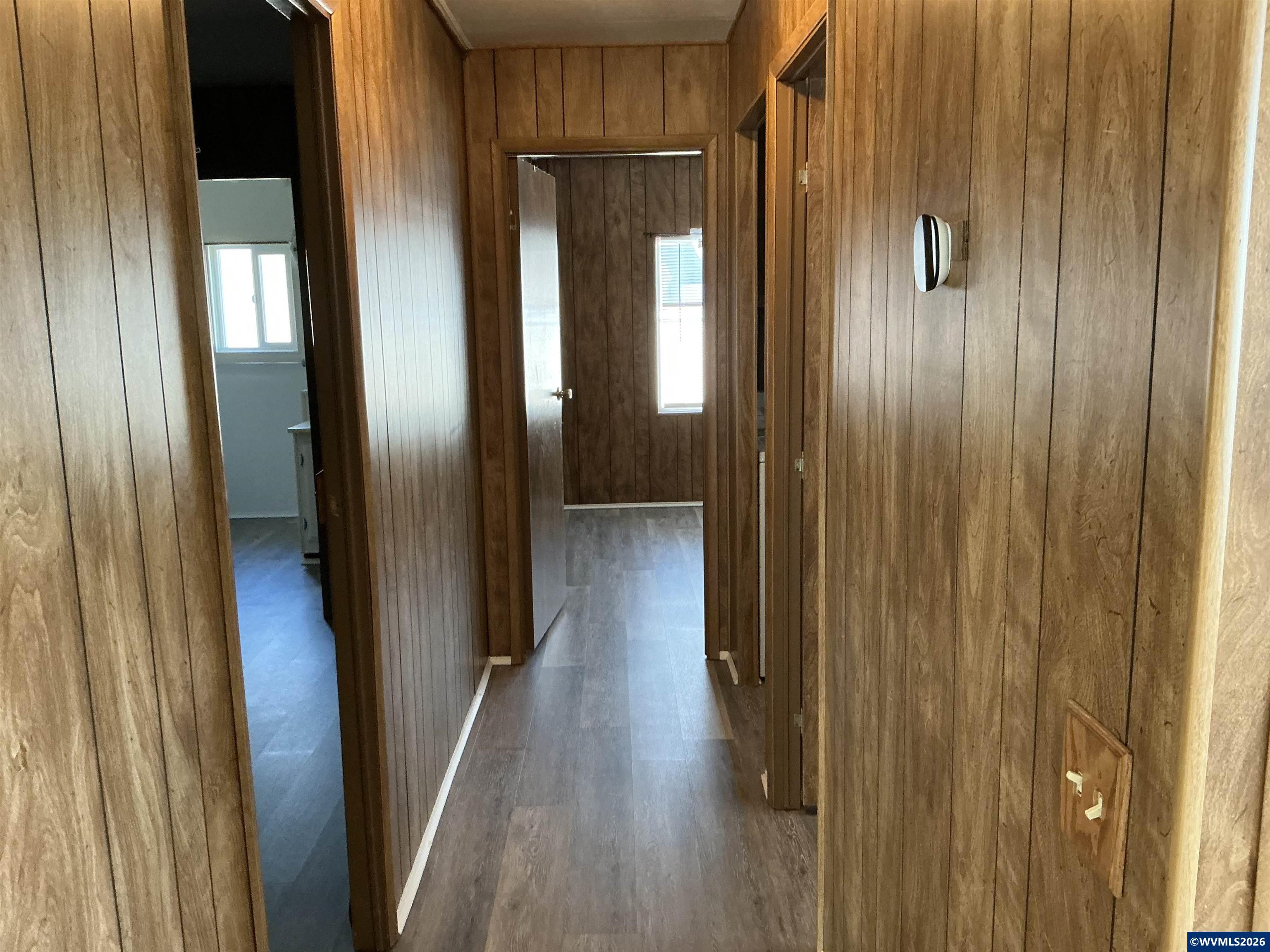 5422 Portland Road Northeast, Unit 67 Salem, OR 97305 - Photo 30 of 45 a view of a hallway with wooden floor