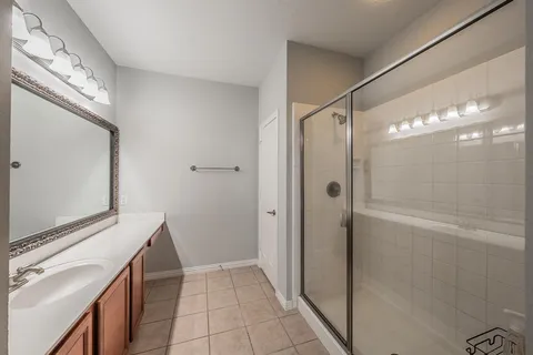 a bathroom with a double vanity sink a mirror and a shower