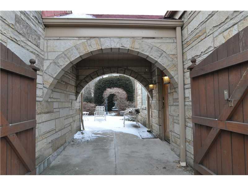 1103 13th Street McKees Rocks, PA 15136 - Photo 22 of 25 Exterior Back. This gated stone breezeway connects the garage to the house