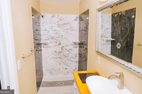 a bathroom with a shower and a sink