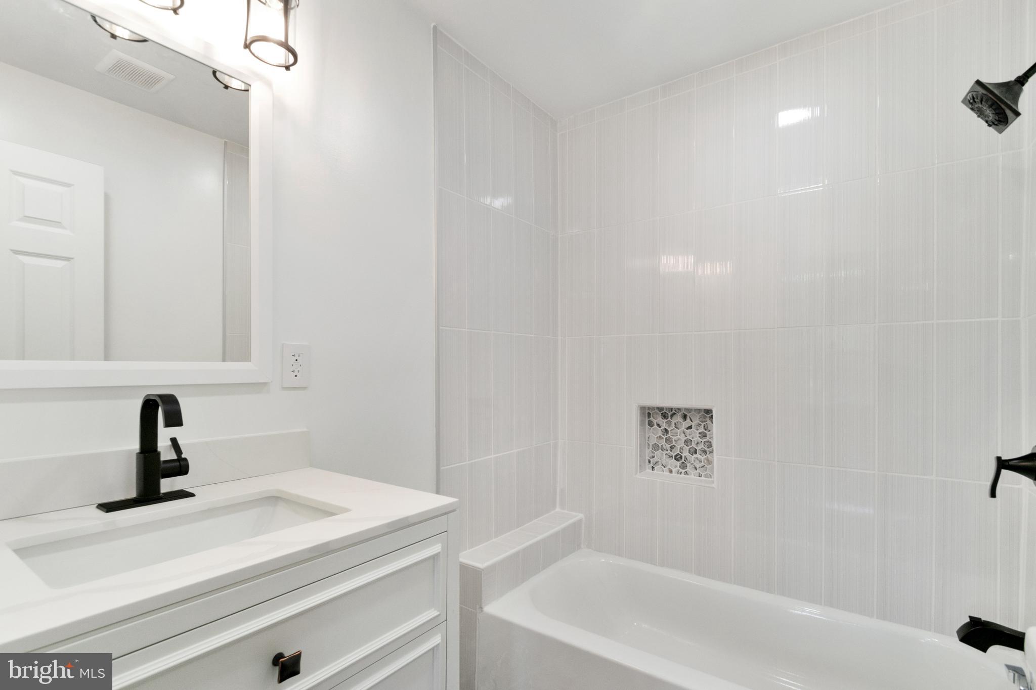 3607 4th Street Baltimore, MD 21225 - Photo 13 of 16 a bathroom with a sink and a bathtub