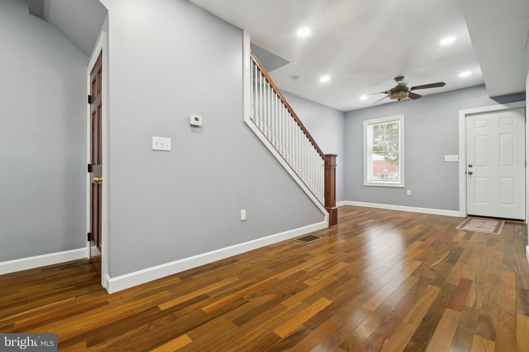 3607 4th Street Baltimore, MD 21225 - Photo 3 of 16 a view of an empty room with wooden floor and a window