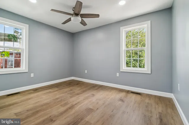 wooden floor in an empty room with a window