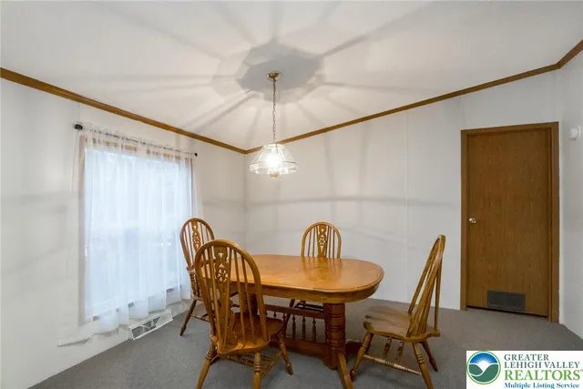 a view of a dining room and a table and chairs