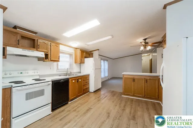a kitchen with wooden floors and white appliances