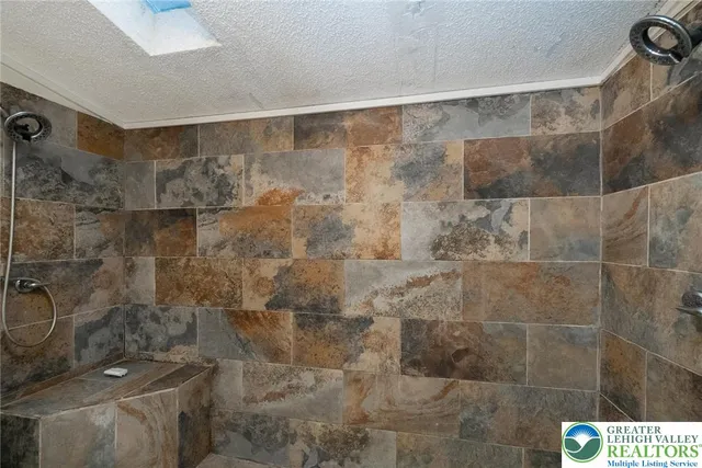 a bathroom with a glass shower door