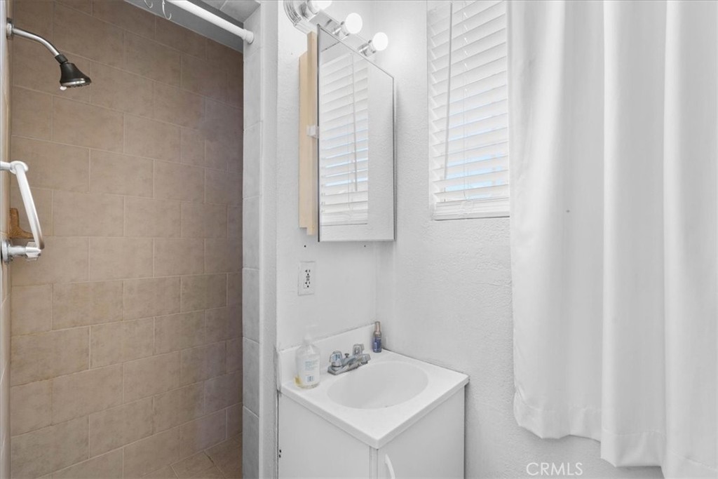 3974 5th Street Riverside, CA 92501 - Photo 27 of 45 a white bath tub sitting next to a white sink