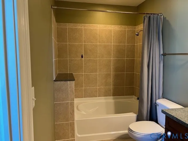 a bathroom with a toilet and shower