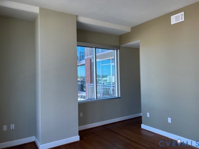301 Virginia Street, Unit 1102 Richmond, VA 23219 - Photo 8 of 28 a view of an empty room with wooden floor and a window