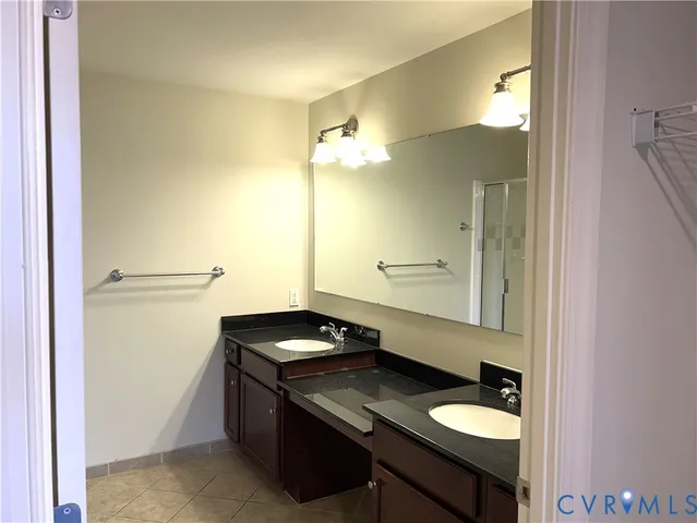 a bathroom with a granite countertop sink a toilet and a mirror