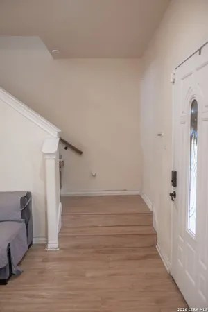 a view of a livingroom with wooden floor and staircase