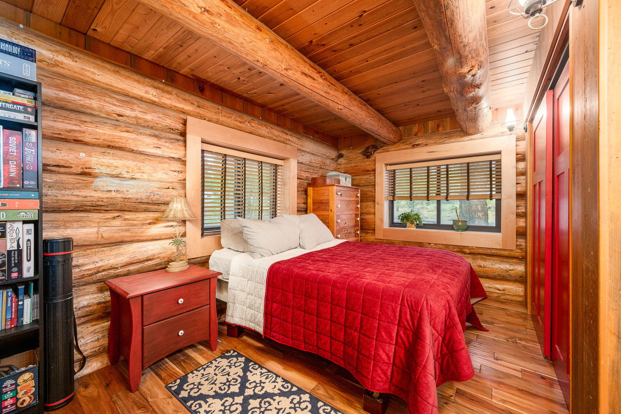 16011 Old Juniper Road Sisters, OR 97759 - Photo 16 of 41 a bedroom with a bed and wooden floor
