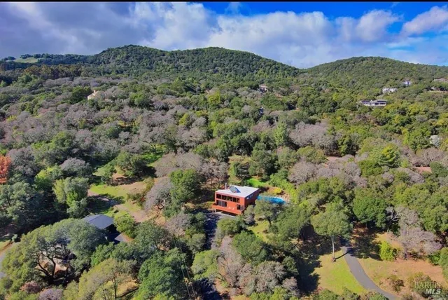 a aerial view of a houses with a yard